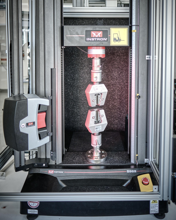  Instron 5969 testing machine with clamped specimen.