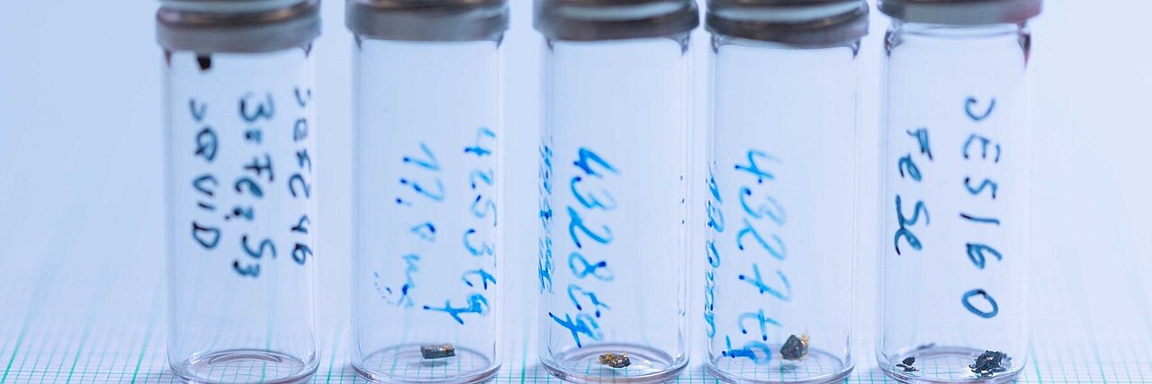 five sample glasses with small single crystals