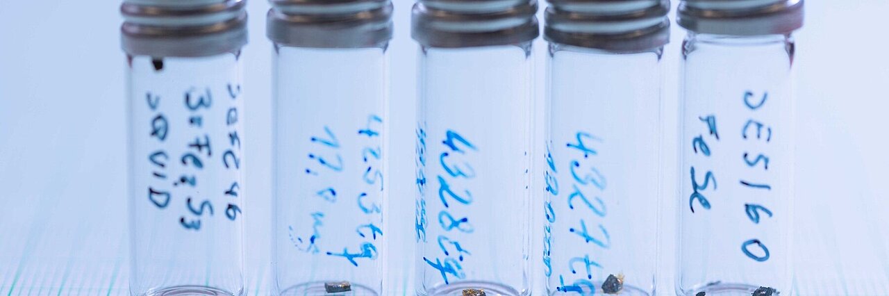five sample glasses with small single crystals