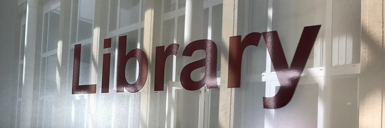 door-sign with the letters l i b r a r y