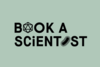 Black text 'BOOK A SCIENTIST' on a greenish background with the 'O' in 'BOOK' replaced by a 20-sided die symbol and the 'I' in 'SCIENTIST' replaced by a stylized bacterium symbol.