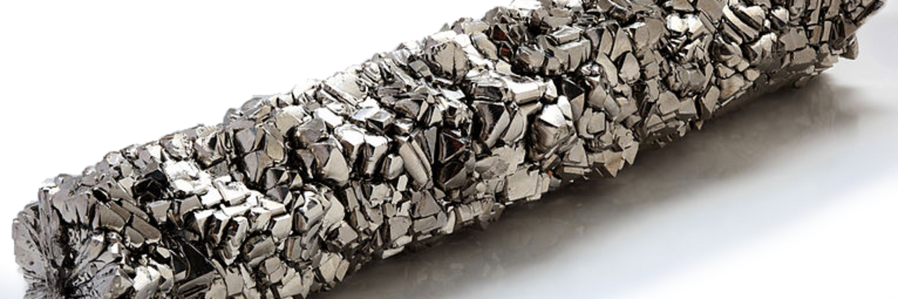 Elongated object with irregular, knobby surface on light background.