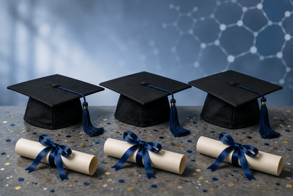 Three graduation caps with tassels placed behind three rolled diplomas tied with ribbons on a confetti-covered surface
