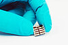 A gloved hand holding a small perovskite solar cell.