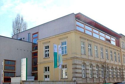 SBG Dresden Building complex with historic multi-story sandstone building and modern annex featuring SBG logo in Dresden.