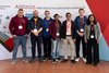 Eine Gruppe Menschen steht vor einer Rückwand mit der Aufschrift zum ASD Workshop 2025 in Leipzig.