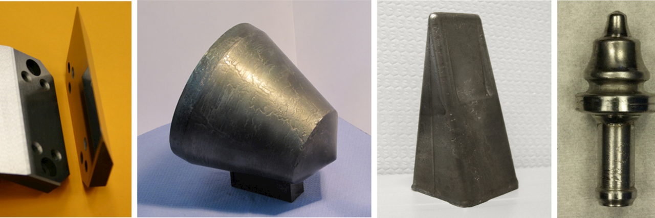 Vier verschiedene Bauteile aus Metall und Kunststoff mit unterschiedlichen Formen auf neutralem Hintergrund.
