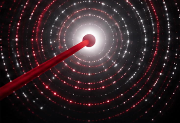 Concentric diffraction rings converge towards a bright centre, symbolizing crystal formation, atomic ordering and phase transformations.